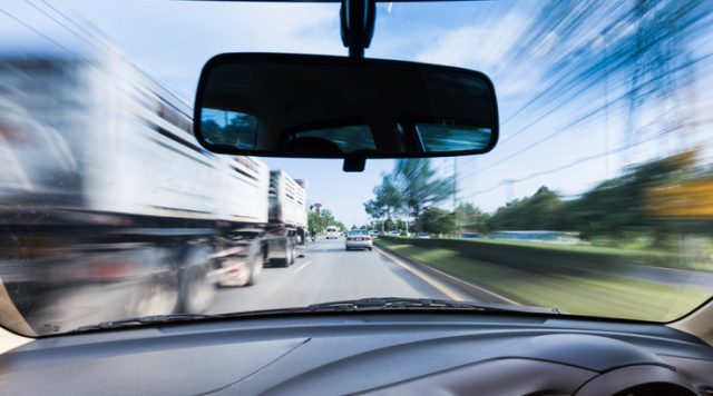Driving at speeds near large trucks .