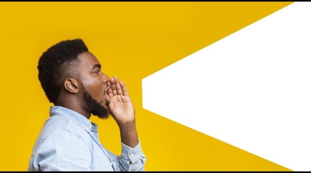 Guy making loud announcement at copy space on yellow background
