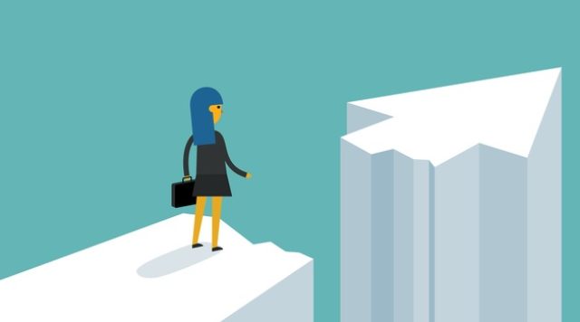 Businesswoman on standing between chasm and success