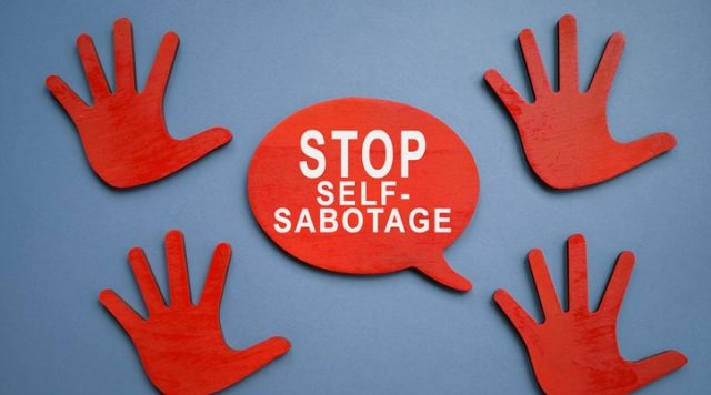Picture of red hands with speach bubble saying "stop self-sabotage"