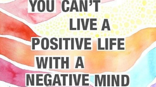 The words "you can't live a positive life with a negative mid" with a rainbow colored background